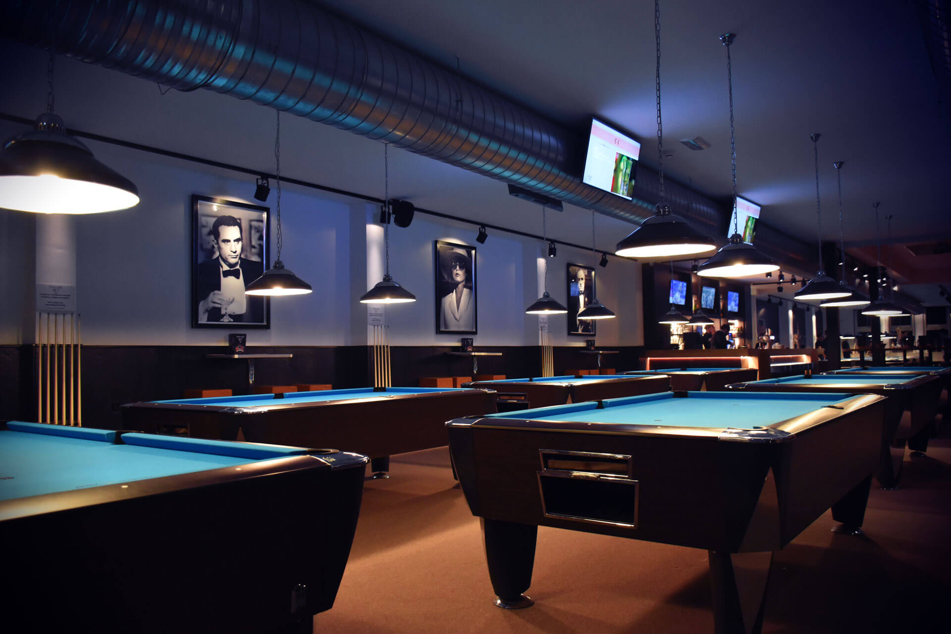 Tables with portraits on the wall