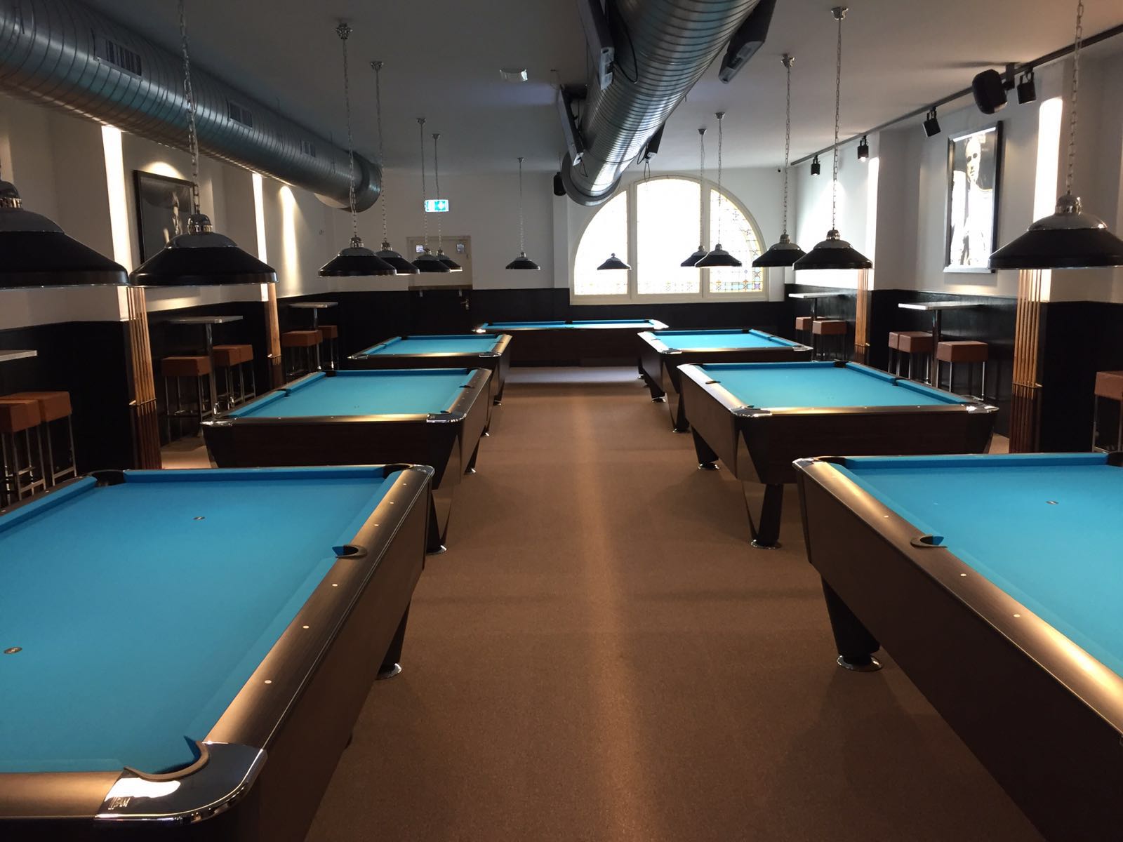 Walkway between the tables with arched windows